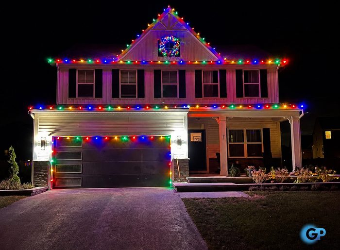 Multicolor C9 roofline, garage and porch lighting on a colonial home